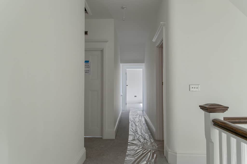 White hallway with grey carpet