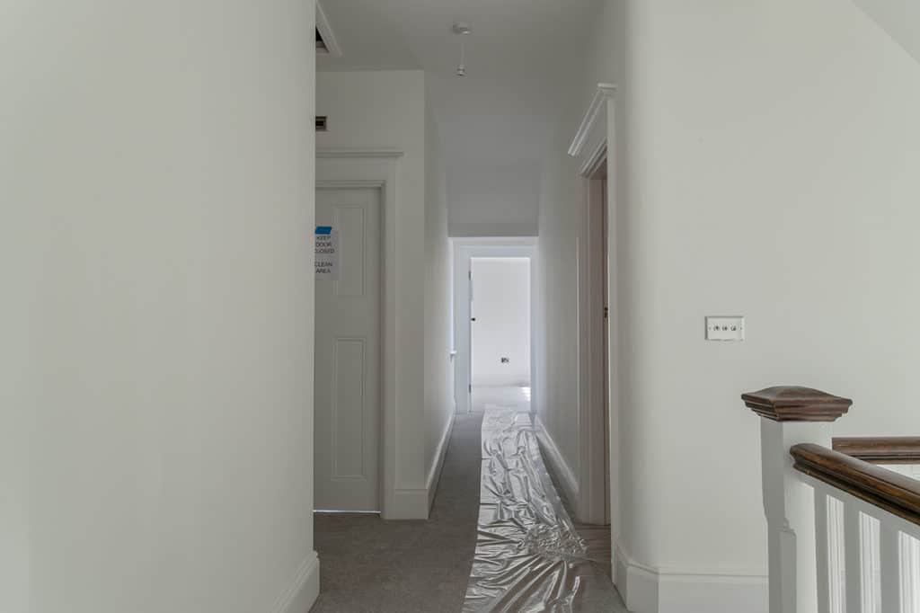 White hallway with grey carpet White hallway with grey carpet